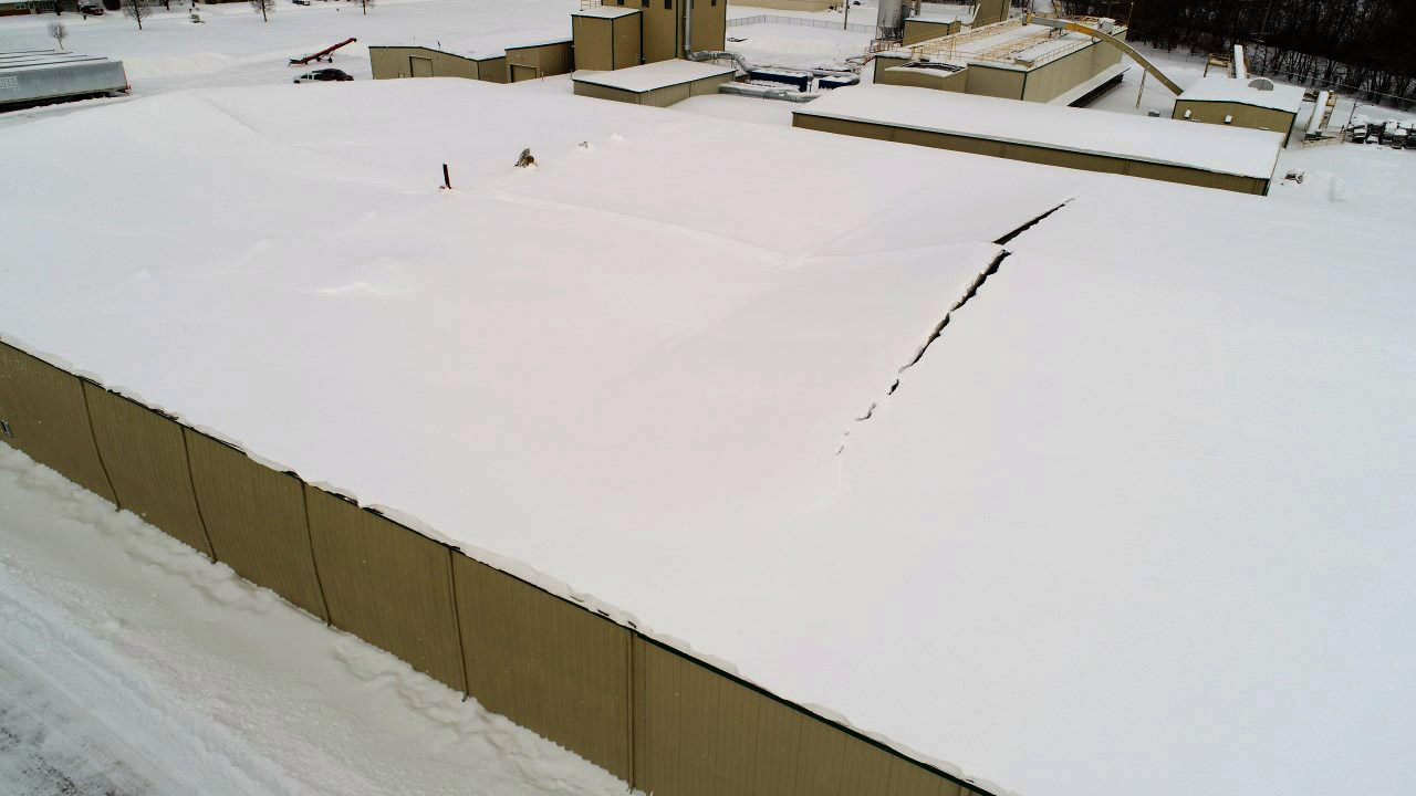 Partially collapsed snow-covered roof